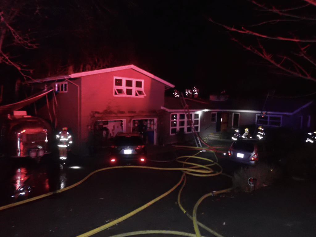 Portland Fire & Rescue battles a house fire started from an electric smoker placed too close to the home.