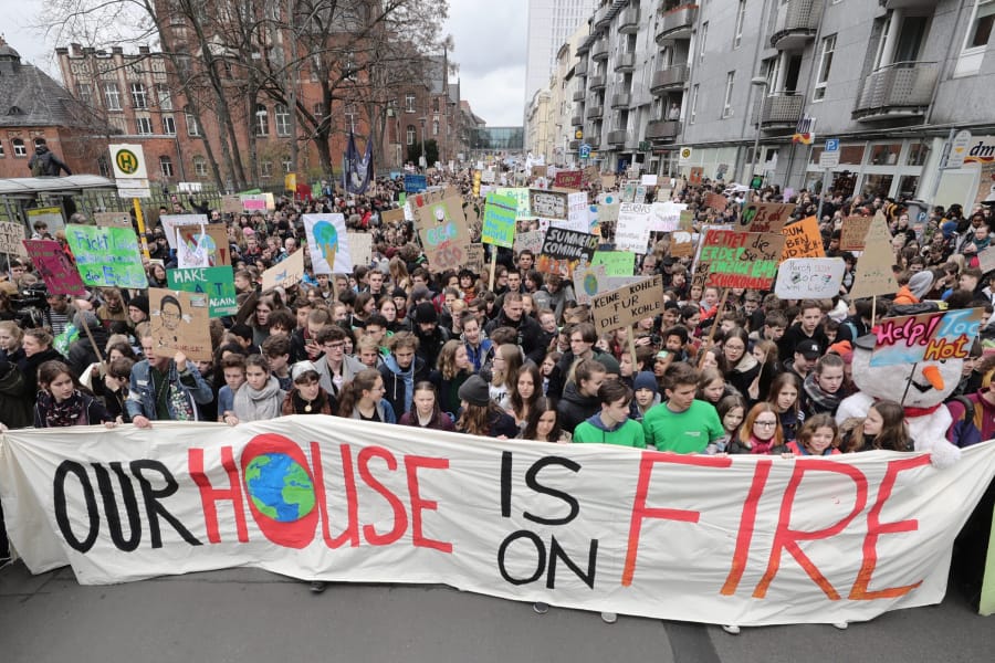 Swedish climate activist Greta Thunberg, center in first row behind the banner, attends the Fridays for Future rally in Berlin, Germany, on March 29. Thousands of students gathered in the German capital, skipping school to take part in a rally demanding action against climate change.