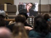 A photo of Nikki Kuhnhausen is placed at the front of the room during the vigil at the Vancouver United Church of Christ in Vancouver on Dec. 20, 2019.