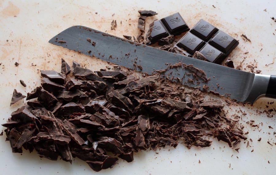 Use a serrated knife to shave the chocolate bar into thin pieces. This will make the chocolate melt more quickly when you pour the hot cream over it. (Photos by E.
