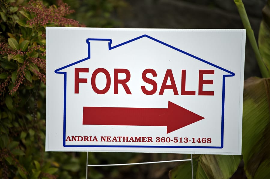 A sign directs home buyers toward a house for sale in Salmon Creek on Oct. 15. Clark County&#039;s housing market continued a run of seasonally high sales activity in November, although there was a decline in new listings.