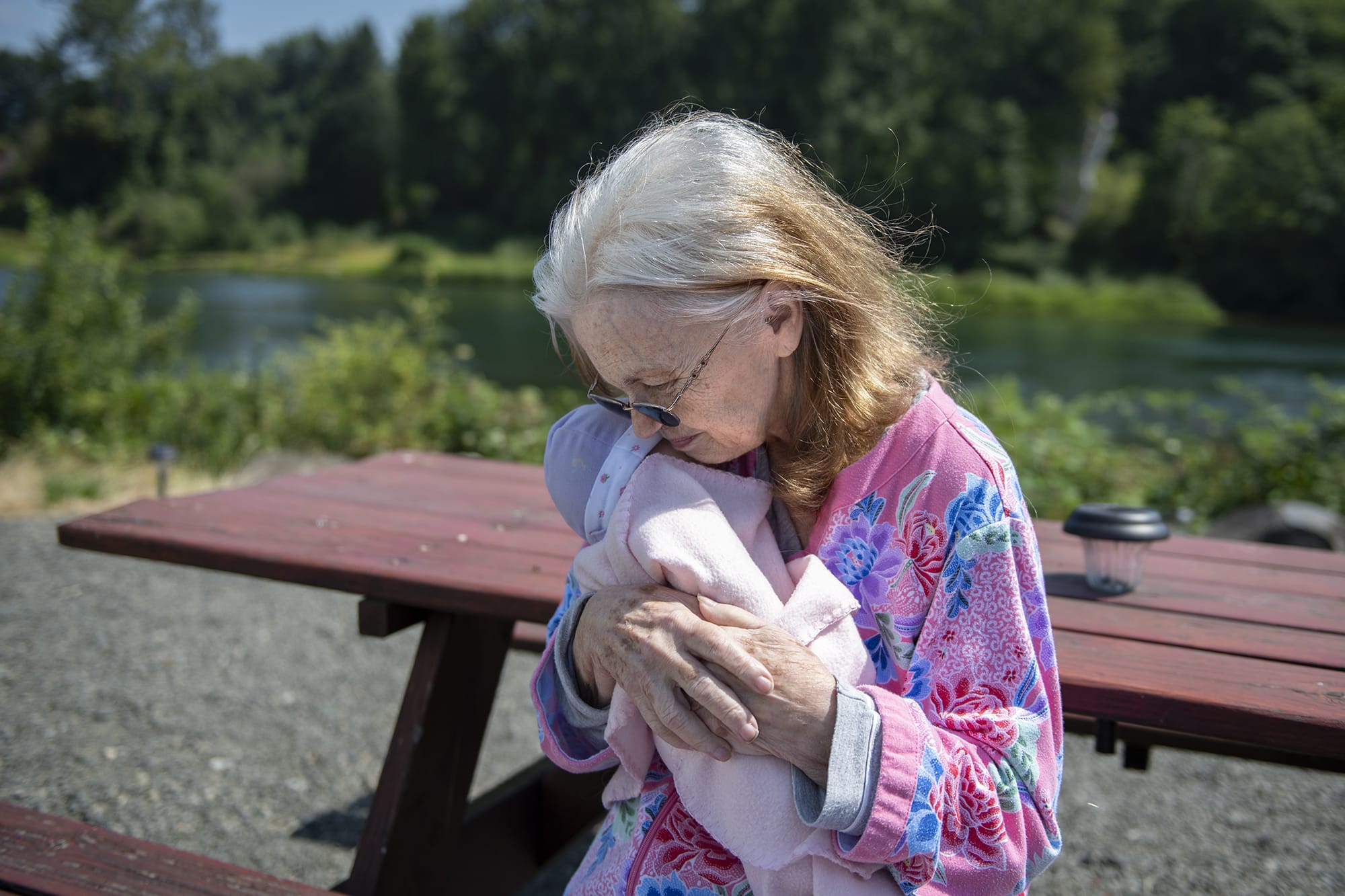 MaryAnn St. Mars affectionately holds her baby doll outside her home on Tuesday morning, August 6, 2019. MaryAnn recently received the baby doll as part of the HOPE Dementia Support Group program.