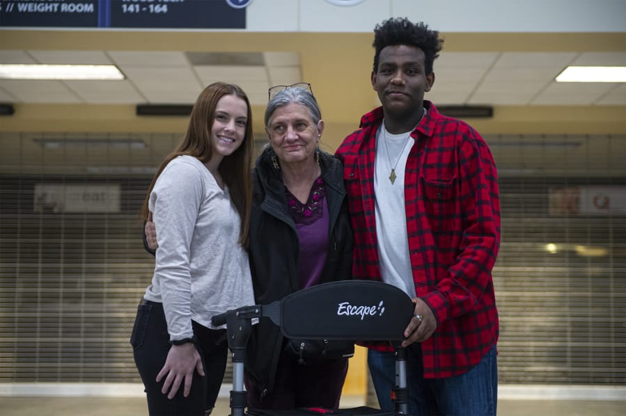 Hayley Oja, from left, Arlene Rose and Musse Barclay at Hockinson High School with a new walker Rose purchased with money raised by two of her students. Rose is a substitute teacher who has a rare neurological disease that inhibits her ability to walk. The students raised money to help her purchase a walker and a wheelchair.