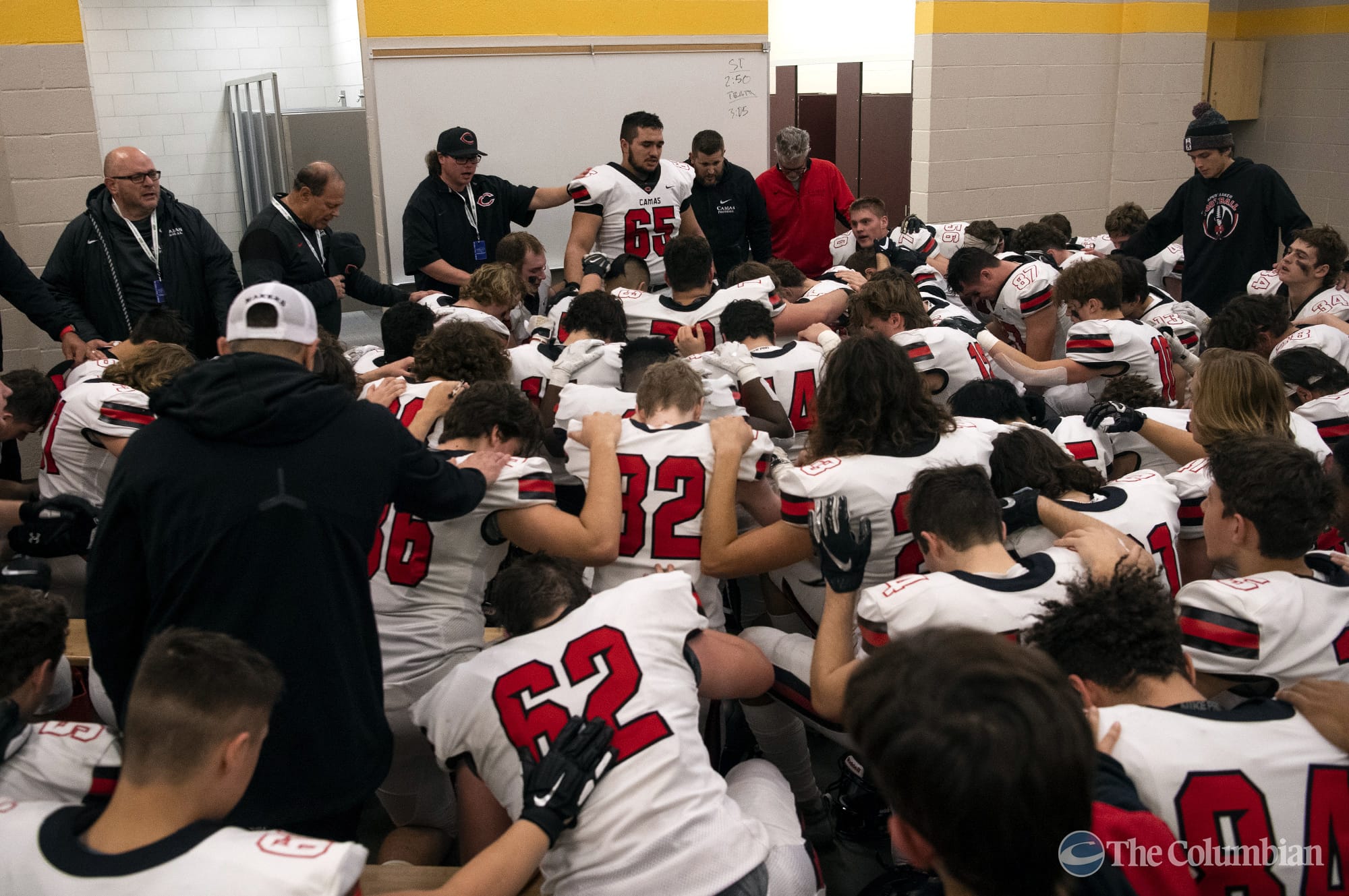Camas kneels for a prayer before Saturday’s Class 4A state championship game against Bothell at Mount Tahoma High School in Tacoma on Dec. 7, 2019.