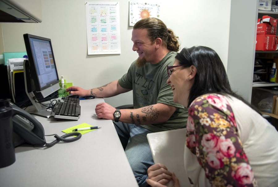Peer mentors Timothy Tipton and Kodi Findlay share a laugh as they work in their office at Clark College in Vancouver. Tipton was released from Larch Corrections Center this summer. While he was at Larch, he was certified as a GED teaching assistant and tutored other inmates.