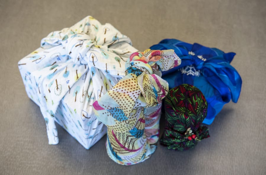 Tina Kendall, environmental outreach specialist for Clark County Public Health, demonstrates furoshiki, the Japanese art of wrapping presents in fabric.