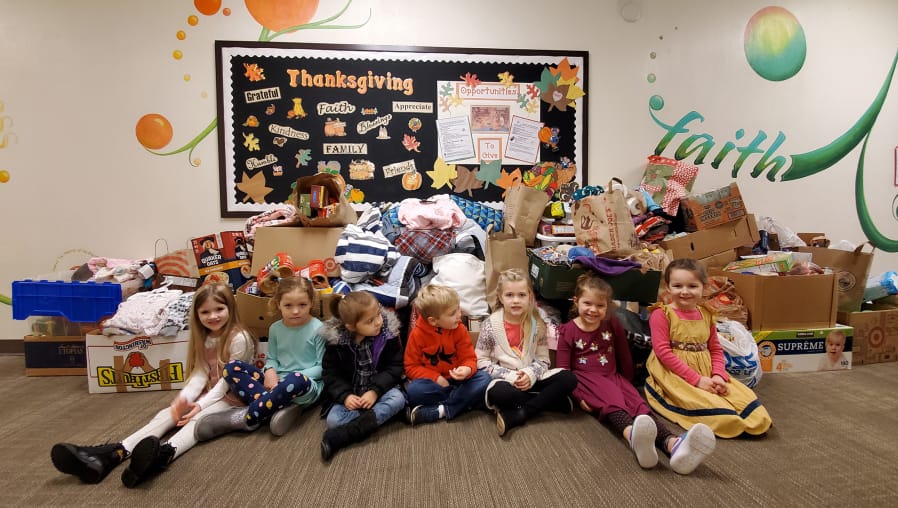 Vancouver Heights: Students at Circle of Friends Preschool with some of the items collected for their needs drive.