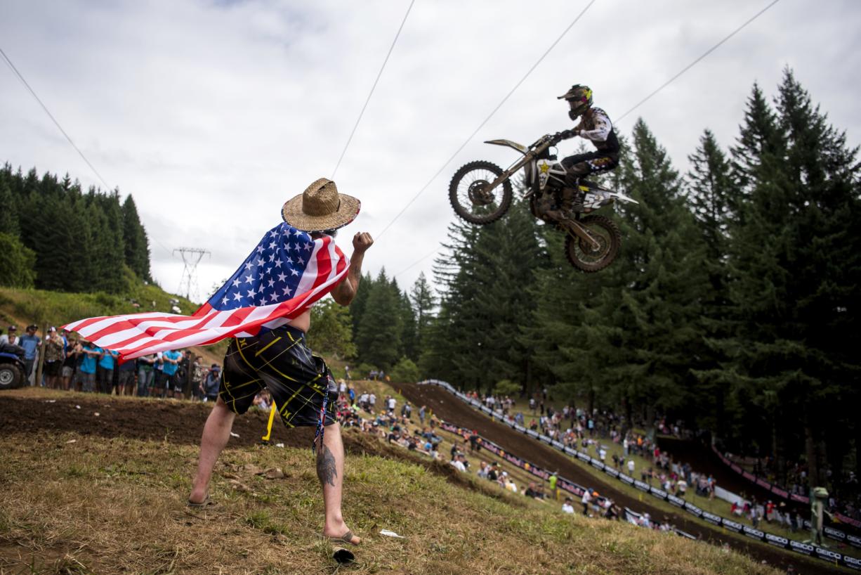 Matt Minor of Salem, Ore., cheers on the riders as they glide over a jump at the top of the course during the Washougal National Lucas Oil Pro Motocross at the Washougal MX Park on Saturday afternoon, July 27, 2019.