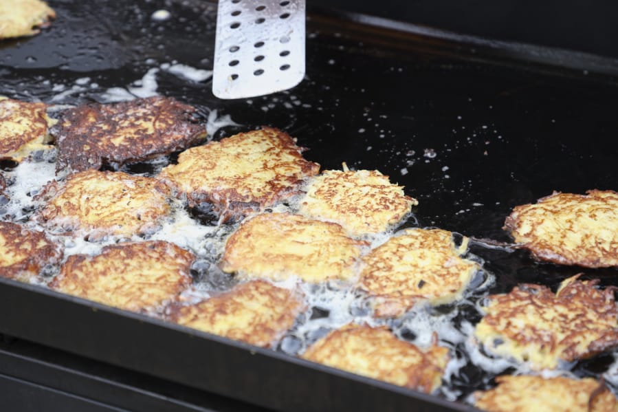 Potato latkes cook on a grill at Congregation Kol Ami. The congregation&#039;s men&#039;s club cooked the potato pancakes for the annual Latke Fest, a potluck held during Hanukkah.
