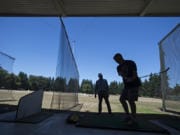 PGA teaching professional Jack Young, left, works with Vancouver resident Slade Langlois while giving him a few helpful tips at Vanco Golf Range on July 26. The city-owned range site is part of the redevelopment area for the Heights District project, and Vanco owner Chuck Milne had previously announced a plan to close the range at the end of 2020. A new lease agreement with the city will now allow the range to operate through 2024.