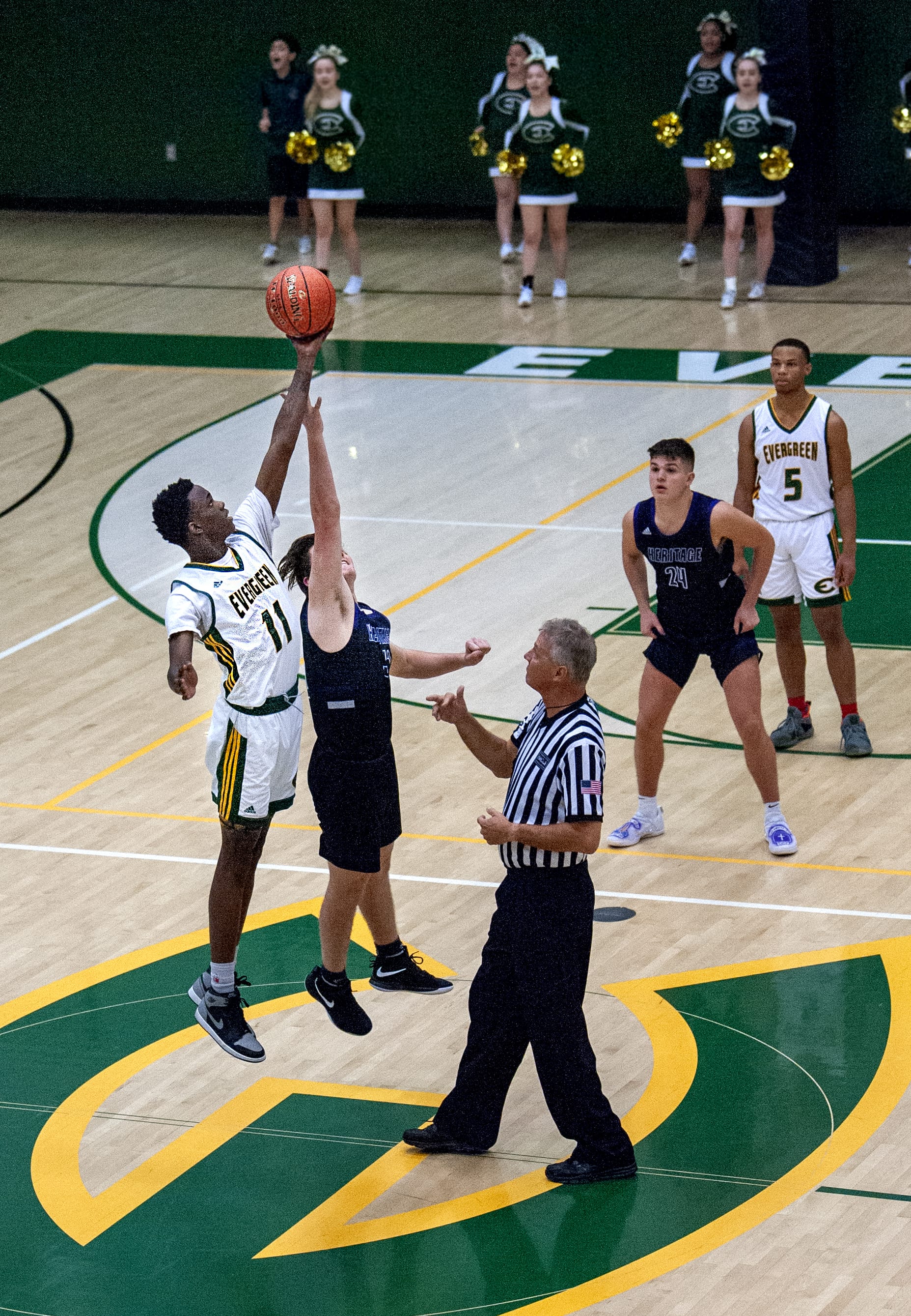 Evergreen’s Mario Herring, left, wins a tipoff over Heritage’s Drew Gray in a nonleague basketball game Tuesday at Evergreen High School. Most Clark County basketball teams begin their 2019-20 season this week.