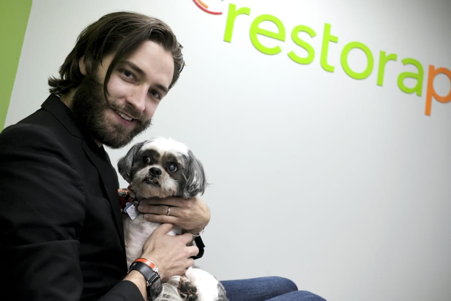 Brian Larsen, holding his buddy Nibber, is the founder and CEO of RestoraPet in Gaithersburg, Md., which makes nutritional supplements for dogs, cats and horses.