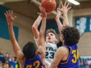 Skyview's Kyle Gruhler makes a game-clinching floater late in the fourth quarter over Columbia River's Marc Miranda (22) and Dylan Valdez (34).