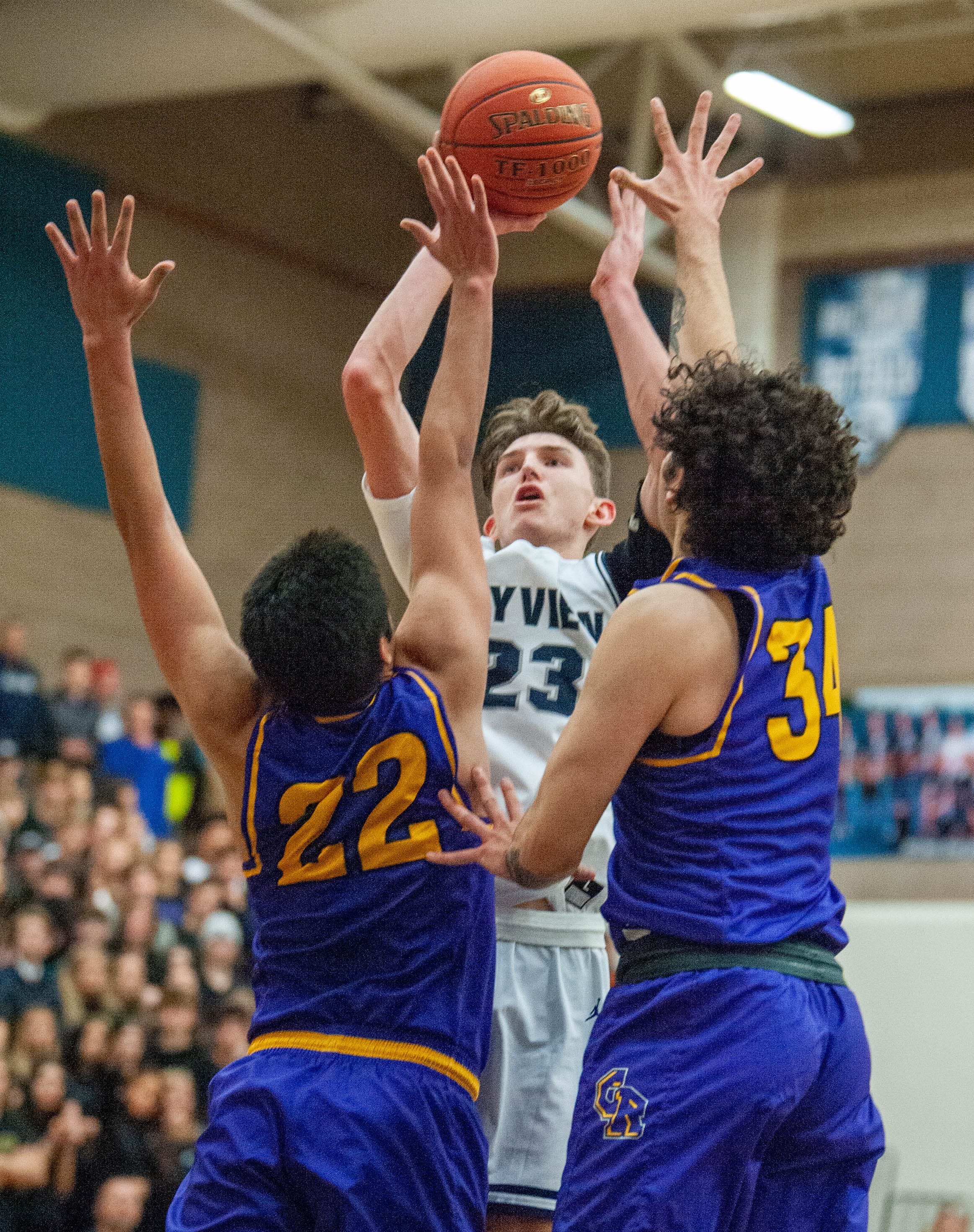 Skyview's Kyle Gruhler makes a game-clinching floater late in the fourth quarter over Columbia River's Marc Miranda (22) and Dylan Valdez (34).
