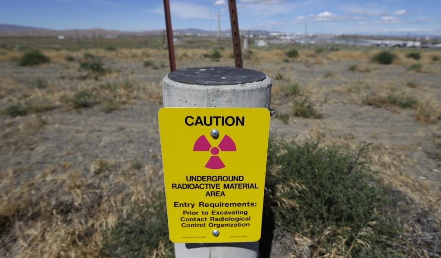 A sign warns of radioactive material stored underground July 11, 2016, on the Hanford Nuclear Reservation near Richland.