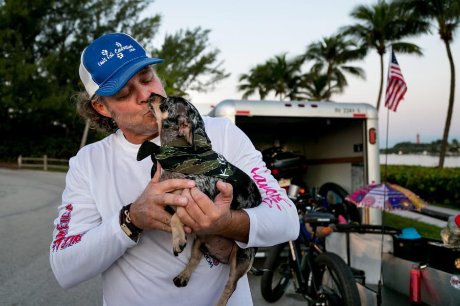 Jay Hamm, prepares to leave on a trip across the U.S. with his two dogs, including K Poppy here, to raise awareness about pet therapy, in Jupiter, Fla., on Nov. 1.