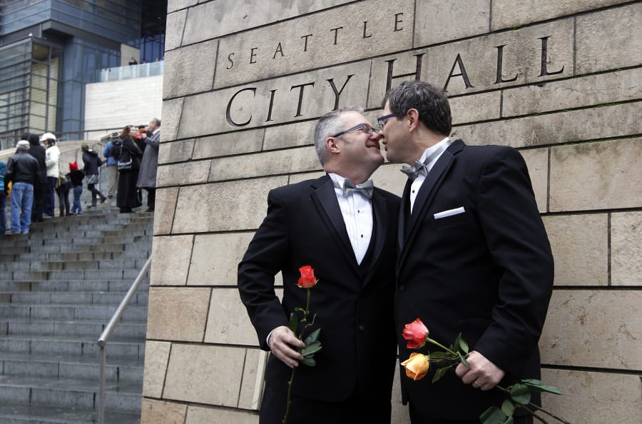 Terry Gilbert, left, kisses his husband Paul Beppler after getting married Dec. 9, 2012, at Seattle City Hall, becoming among the first gay couples to legally wed in the state, in Seattle.  The Legislature approved in early 2012, and voters agreed in the fall, to legalize same-sex marriage, putting Washington ahead of the 2015 U.S. Supreme Court ruling that protected same sex marriage in all states.