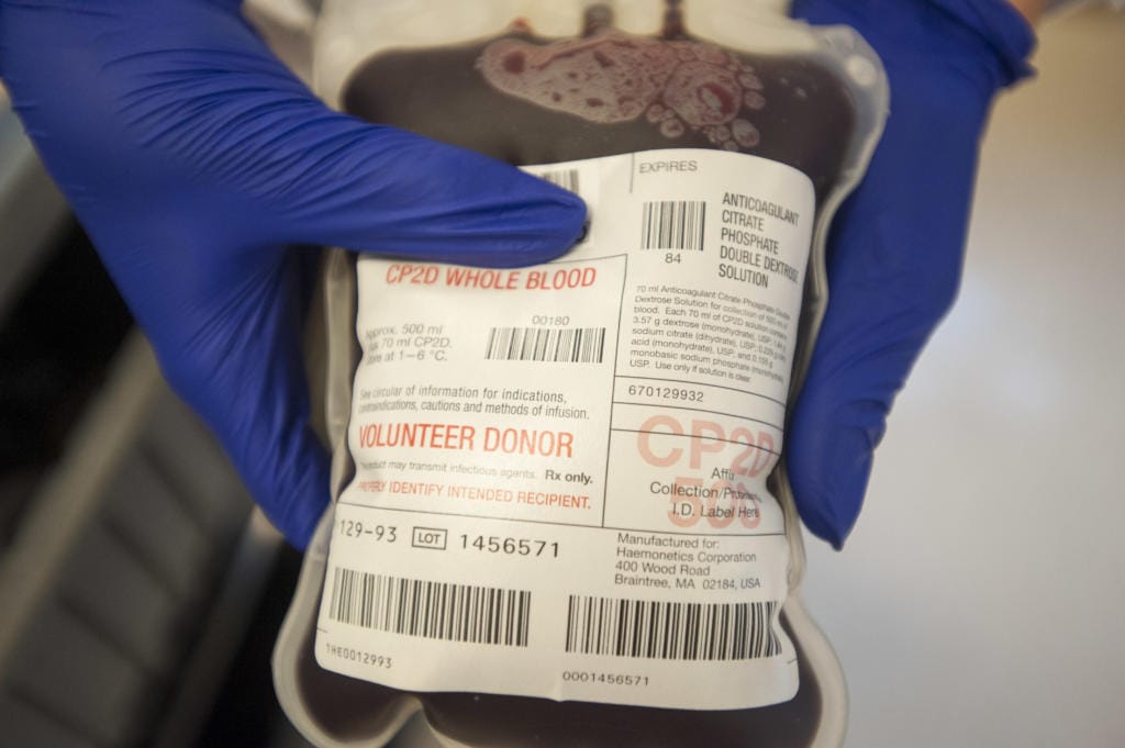 A technician holds some bags of fresh blood at a blood drive hosted by Bloodworks Northwest in Vancouver in 2015.