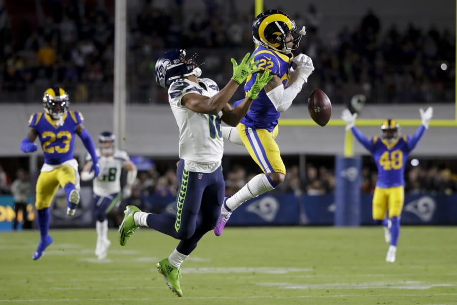 Los Angeles Rams cornerback Troy Hill breaks up a pass intended for Seattle Seahawks wide receiver Tyler Lockett during the first half of an NFL football game Sunday, Dec. 8, 2019, in Los Angeles.