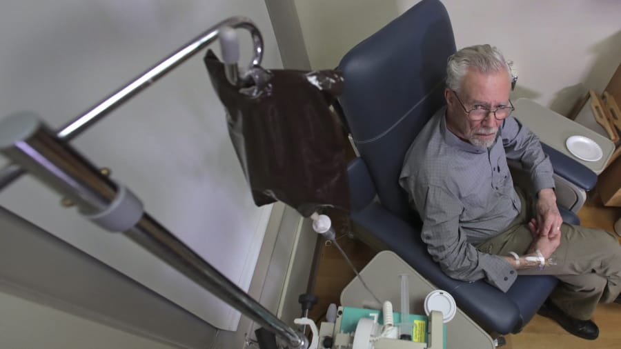In this Nov. 22, 2019, photo, Charles Flagg, who is stricken with Alzheimer&#039;s disease, receives the contents of an intravenous bag while participating in a study on the drug Aducanumab at Butler Hospital in Providence, R.I. New results were released on the experimental medicine whose maker claims it can slow the decline of Alzheimer&#039;s disease, the most common form of dementia.