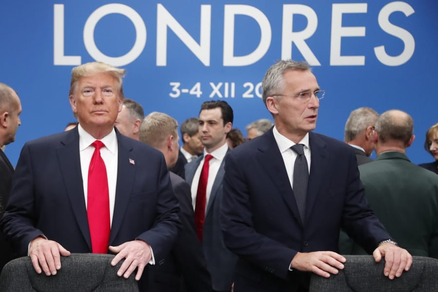 In this Dec. 4, 2019, photo, U.S. President Donald Trump and NATO Secretary General Jens Stoltenberg wait to take their seats prior to a NATO leaders meeting at The Grove hotel and resort in Watford, Hertfordshire, England. Three years into the Trump presidency, America&#039;s new place in the world is coming into focus, with influence waning from NATO meeting rooms to the Middle East to the capital cities of key allies. And in many ways, that&#039;s just fine with the White House.