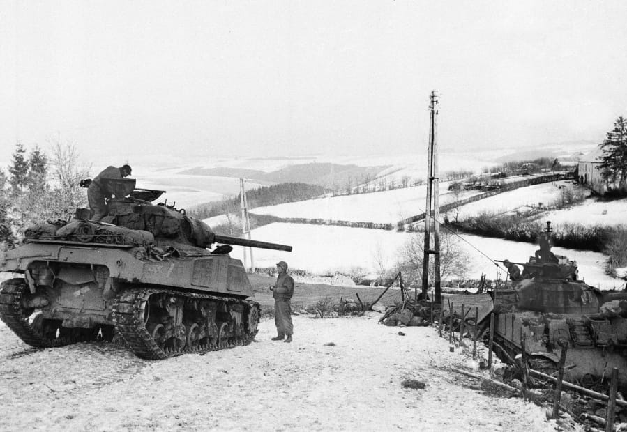 In this Jan. 6, 1945 file photo, American tanks wait on the snowy slopes in Bastogne,Belgium. It was 75 years ago that Hitler launched his last desperate attack to turn the tide for Germany in World War II. At first, German forces drove so deep through the front line in Belgium and Luxembourg that the month-long fighting came to be known as The Battle of the Bulge. When the Germans asked one American commander to surrender, the famous reply came: &quot;Nuts!&quot; By Christmas, American troops had turned the tables on the Germans. Veterans are heading and on Monday, Dec. 16, 2019 when they will mix with royalty and dignitaries to mark perhaps the greatest battle in U.S. military history.