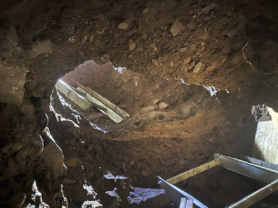 This Dec. 9, 2019 photo provided by U.S. Customs and Border Protection (CBP) shows an access point to a tunnel between Nogales, Mexico, and Nogales, Ariz., seen from the U.S. side. The CBP says it busted another cross-border tunnel after arresting a group of four migrants. The agency says agents in Nogales, Ariz., made the discovery on Sunday after a camera operator spotted the migrants. It was just 50 yards (45.7 meters) east of another tunnel that was discovered last week, although that one was incomplete. The Border Patrol says it worked with Mexican authorities to trace the tunnel to Mexico and that it has since destroyed it.