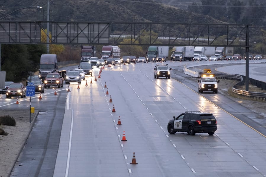 Traffic on the northbound side of the I-5 freeway is diverted off at Parker road in Castaic, Calif., as snow on the Grapevine has made the road impassable Thursday, December 26, 2019. The CHP had no estimate as to when the freeway would re-open.