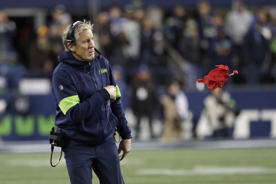 Seattle Seahawks head coach Pete Carroll throws a challenge flag near the end of an NFL football game against the Arizona Cardinals, Sunday, Dec. 22, 2019, in Seattle.