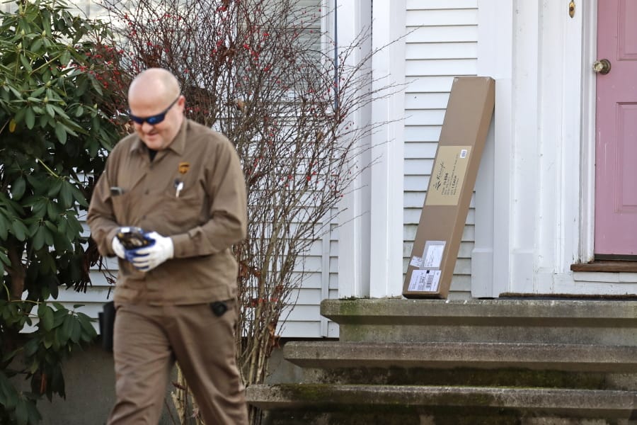 In this Nov. 26, 2019, photo a UPS man delivers a package to a residence in North Andover, Mass.  &quot;Cyber Monday&quot; is still holding up as the biggest online shopping day of the year, even though the same deals have been available online for weeks and the name harks back to the days of dial-up modems.