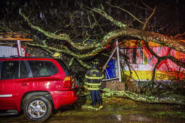 Cory Simpson of Decatur Fire & Rescue assess damage before evacuating a mobile home after a tree fell on the home in Decatur, Ala., Monday, Dec. 16, 2019. Powerful storms smashed buildings, splintered trees and downed power lines Monday around the Deep South, leaving at least one person dead as the dangerous mix of thunderstorms and suspected tornadoes raked the region in the week ahead of Christmas.