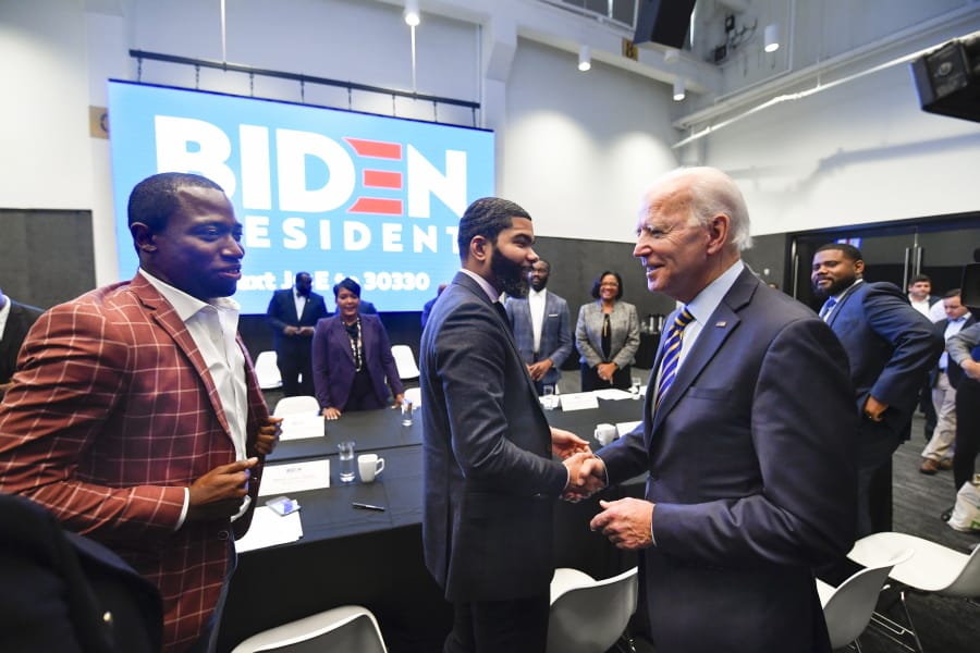 Democratic presidential candidate former Vice President Joe Biden, right, meets Nov. 21 with an assembly of Southern black mayors including Mississippi Mayor Chokwe Lumumba and Virginia Mayor Levar Stoney, left, in Atlanta.