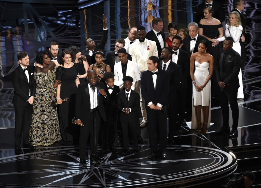 FILE - This Feb. 26, 2017 file photo shows Barry Jenkins and the cast and crew of &quot;Moonlight&quot; accepting the award for best picture at the Oscars in Los Angeles.