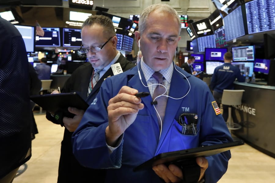 Traders Robert Arciero, left, and Timothy Nick work on the floor of the New York Stock Exchange, Wednesday, Dec. 4, 2019. Stocks are opening broadly higher as traders became more hopeful that a trade deal between the U.S. and China was making progress.