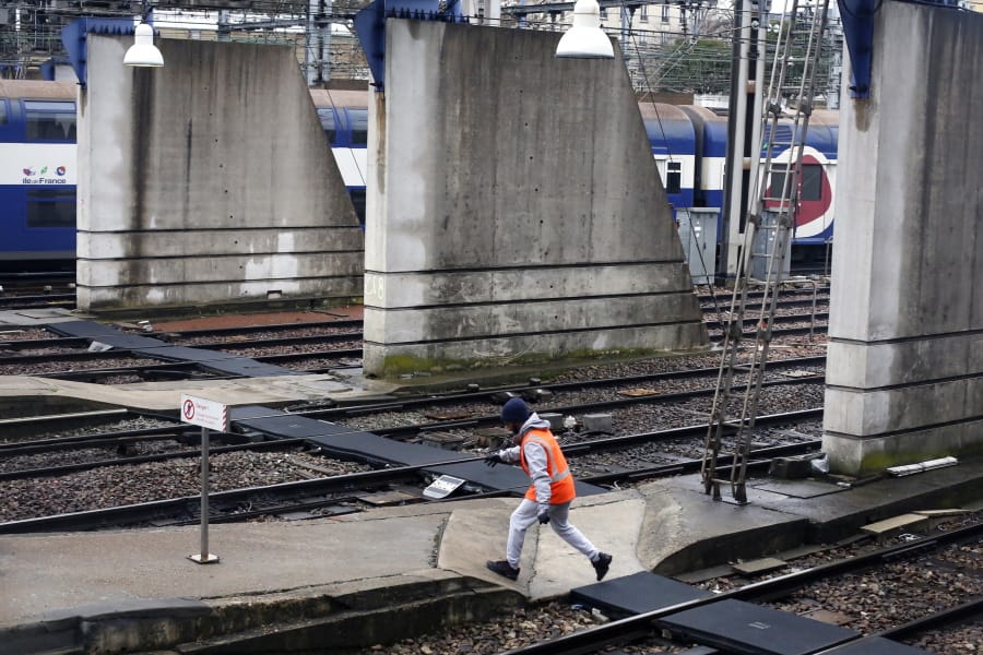 A worker walks on a platform at the Gare Montparnasse railway station, in Paris, Wednesday, Dec. 11, 2019. After hundreds of thousands of angry protesters marched through French cities, the prime minister is expected to unveil proposals that might calm tensions on the 7th straight day of a crippling transport strike.