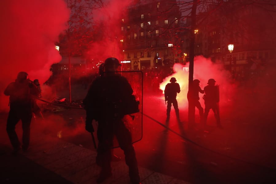 Riot police officers secure an area during a demonstration in Paris, Thursday, Dec. 5, 2019. Small groups of protesters are smashing store windows, setting fires and hurling flares in eastern Paris amid mass strikes over the government&#039;s retirement reform.