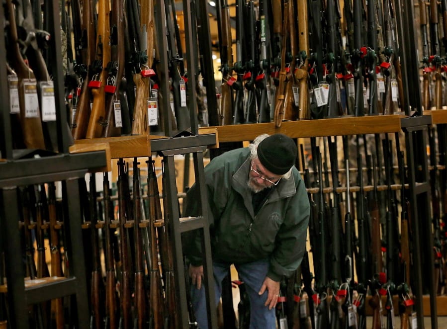 A man looks at the shotgun section of Cabela&#039;s while shopping on Black Friday in Hazelwood, Mo. (Christian Gooden/St.