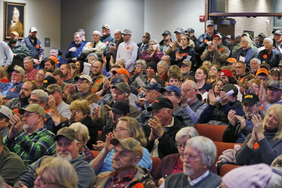 Spectators applaud as the Buckingham County Board of Supervisors unanimously voted to pass a Second Amendment Sanctuary City resolution at a meeting in Buckingham , Va., Monday, Dec. 9, 2019. The board passed the resolution without any public discussion.