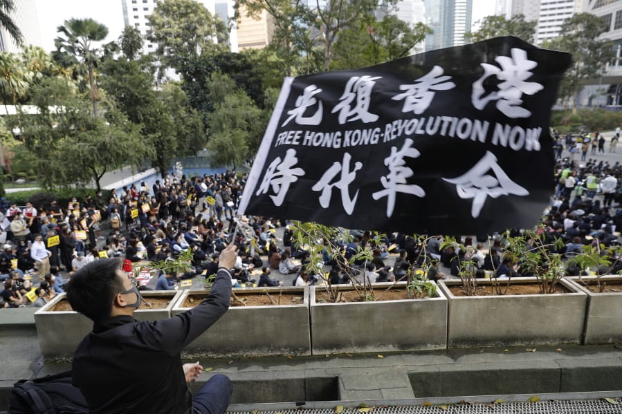 A pro-democracy supporter waves a flag during a rally by the advertising industry in Hong Kong on Monday, Dec. 2, 2019. Thousands of people took to Hong Kong&#039;s streets Sunday in a new wave of pro-democracy protests, but police fired tear gas after some demonstrators hurled bricks and smoke bombs, breaking a rare pause in violence that has persisted during the six-month-long movement.
