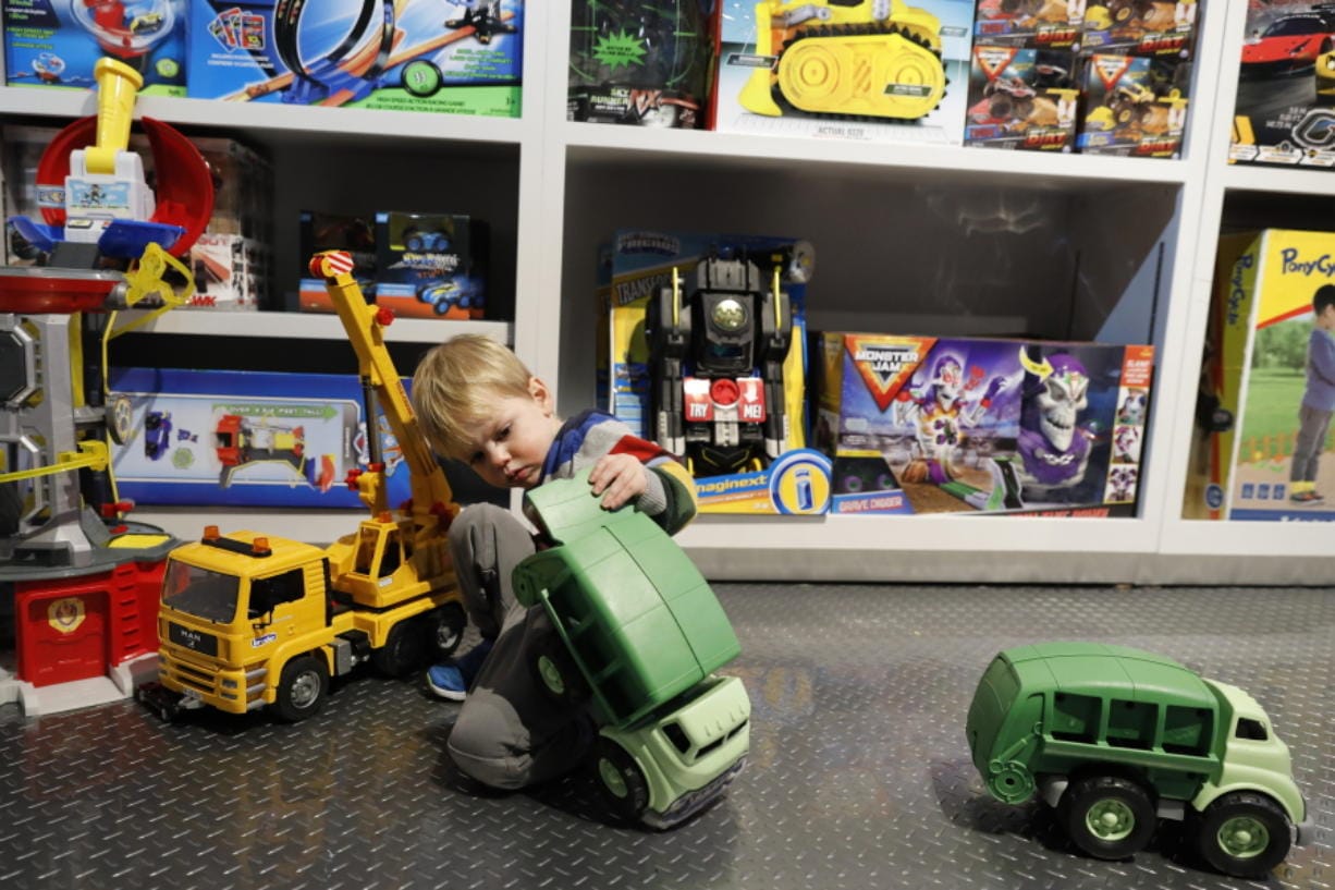Maxwell MacIsaac, 2, plays with trucks at Camp toy store in New York. Camp, which was founded last year, not only sells toys but has also workshops and interactive areas for children. The concept is expanding to other locations and is the latest offering in experiential retail.