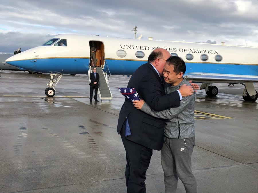 This photo provided by U.S. Embassy Switzerland,  Edward McMullen greets Xiyue Wang in Zurich, Switzerland on Saturday, Dec. 7, 2019.  In a trade conducted in Zurich, Iranian officials handed over Chinese-American graduate student Xiyue Wang, detained in Tehran since 2016, for scientist Massoud Soleimani, who had faced a federal trial in Georgia.  (U.S.