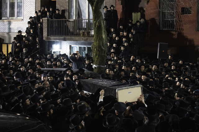 Orthodox Jewish men carry Moshe Deutsch's casket outside a Brooklyn synagogue following his funeral, Wednesday, Dec. 11, 2019 in New York. Deutsch was killed Tuesday in a shooting inside a Jersey City, N.J. kosher food market.