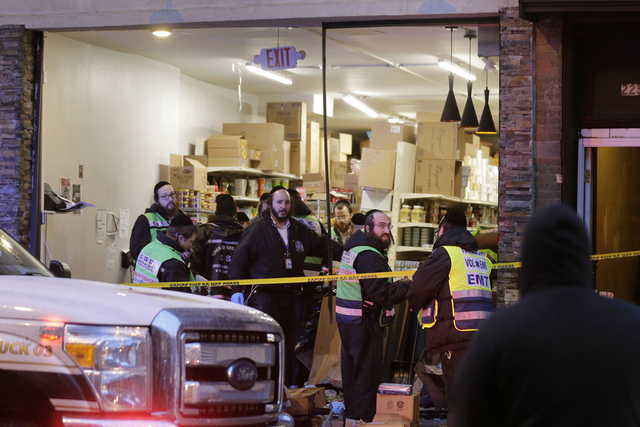 Emergency responders work at a kosher supermarket, the site of a shooting in Jersey City, N.J., Wednesday, Dec. 11, 2019. Jersey City Mayor Steven Fulop said gunmen targeted the market during a shooting that killed multiple people Tuesday.