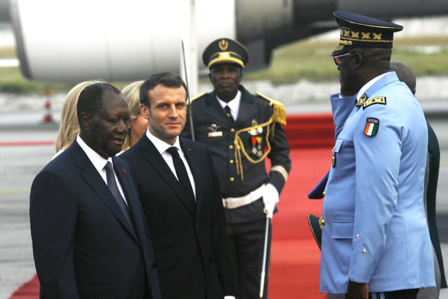 French President Emmanuel Macron is welcomed Friday by President Alassane Ouattara upon arrival in Abidjan, Ivory Coast. Macron is in Ivory Coast for a three-day official visit.