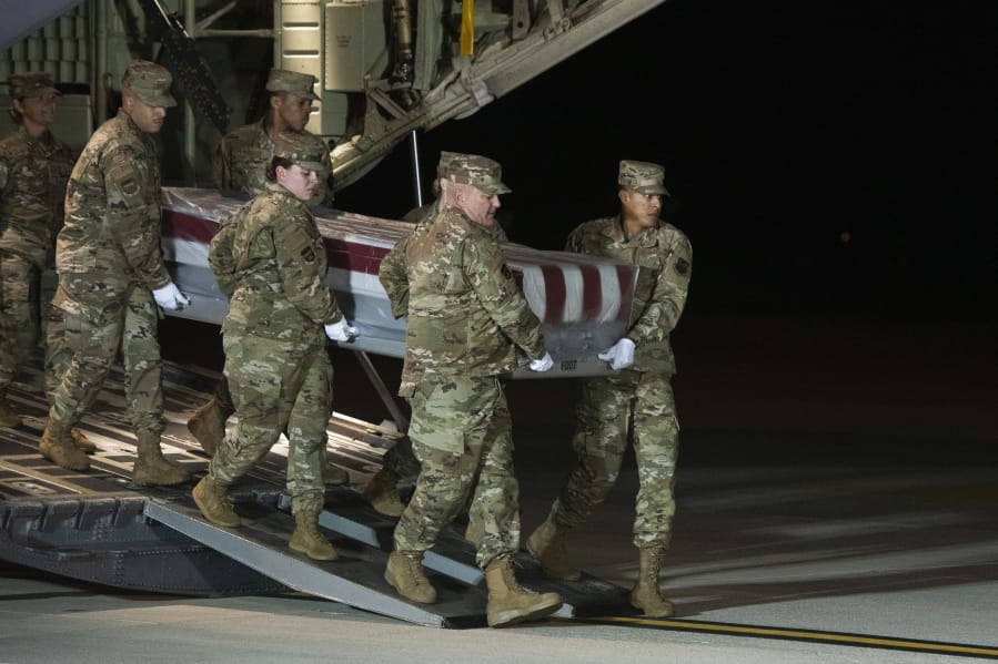 An Air Force carry team moves the transfer case containing the remains of Navy Seaman Apprentice Cameron Scott Walters, of Richmond Hill, Ga., Sunday, Dec. 8, 2019, at Dover Air Force Base, Del. A Saudi gunman killed three people including Walters in a shooting at Naval Air Station Pensacola in Florida.