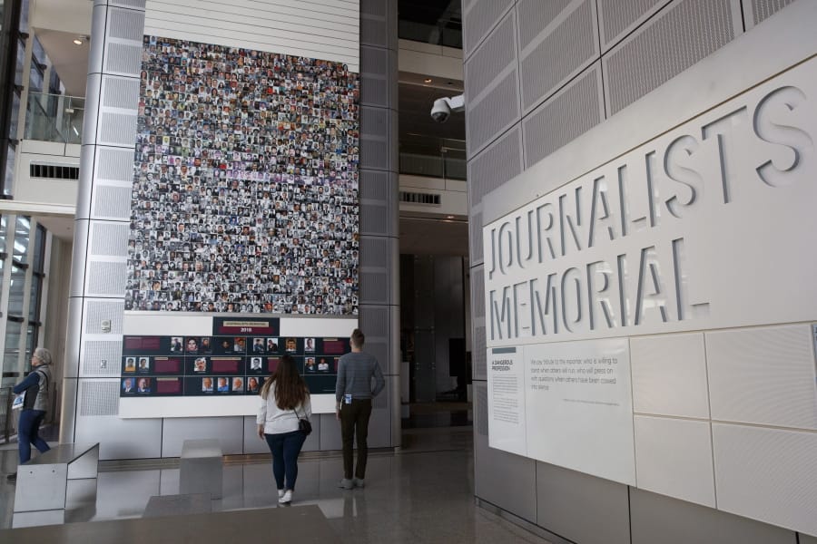 People visit the journalists memorial Friday at the Newseum in Washington.
