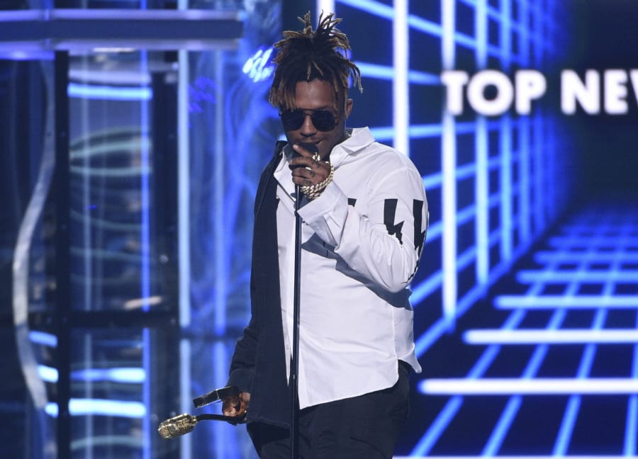 FILE - In this May 1, 2019 file photo, Juice WRLD accepts the award for top new artist at the Billboard Music Awards at the MGM Grand Garden Arena in Las Vegas. The Chicago-area rapper, whose real name is Jarad A. Higgins, was pronounced dead Sunday, Dec. 8 after a &quot;medical emergency&#039;&#039; at Chicago&#039;s Midway International Airport, according to authorities. Chicago police said they&#039;re conducting a death investigation.