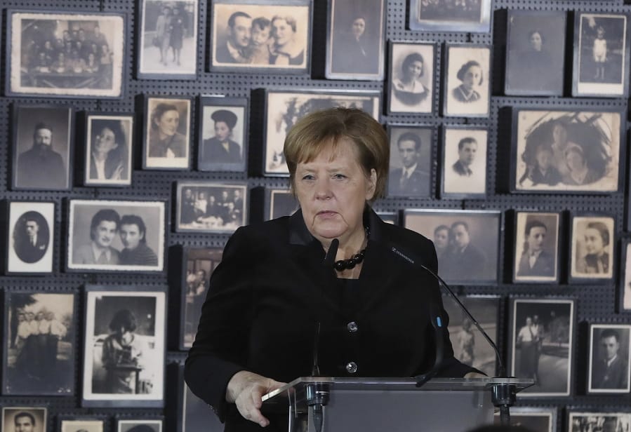 German Chancellor Angela Merkel speaks in the building of the so-called &quot;Sauna&quot; during her visit at the former Nazi German concentration and extermination camp Auschwitz-Birkenau in Oswiecim, Poland on Friday, Dec. 6, 2019. Merkel attends an event in occasion of the 10th anniversary of the founding of the Auschwitz Foundation.