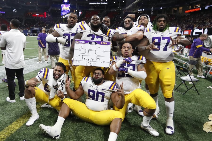 LSU players celebrate after the Southeastern Conference championship NCAA college football game against Georgia, Saturday, Dec. 7, 2019, in Atlanta. LSU won 37-10.