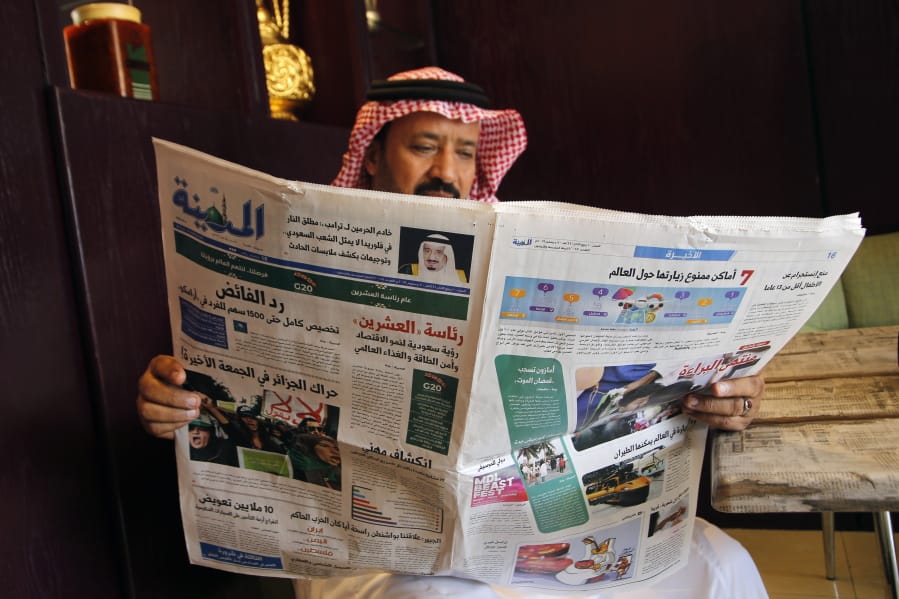 A man reads the daily Al-Madina newspaper fronted by a picture of Saudi King Salman at a coffee shop in Jiddah, Saudi Arabia, Saturday, Dec. 7, 2019. U.S. law enforcement officials were digging into the background of the suspected Florida naval station shooter Friday, to determine the Saudi Air Force officer&#039;s motive and whether it was connected to terrorism. Arabic at top reads &quot;King Salman to Donald J.